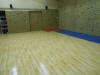 Level 10 Fitness rock wall and yoga room with Sport Court Maple Select flooring.